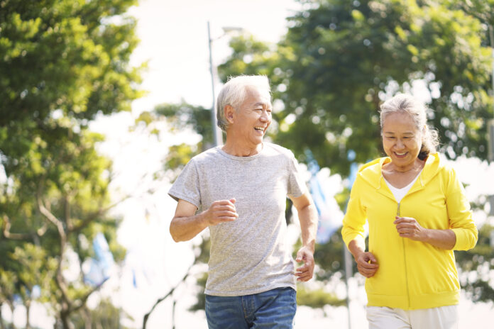 senior asian couple jogging outdoors