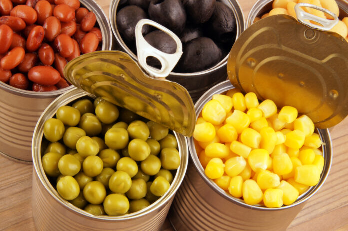 Canned food on wooden background