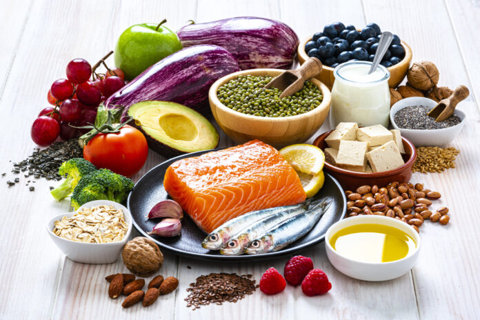 Foods to lower cholesterol shot on white table healthy heart