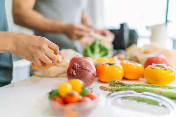 Close-up photo of woman's hand while preparing vegan food at home