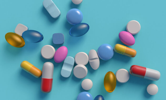 Heap of medical drugs on blue backdrop