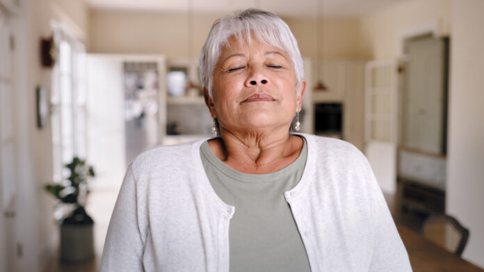 Shot of an elderly woman taking a deep breath and enjoying the fresh air at home Devices for lowering blood pressure.