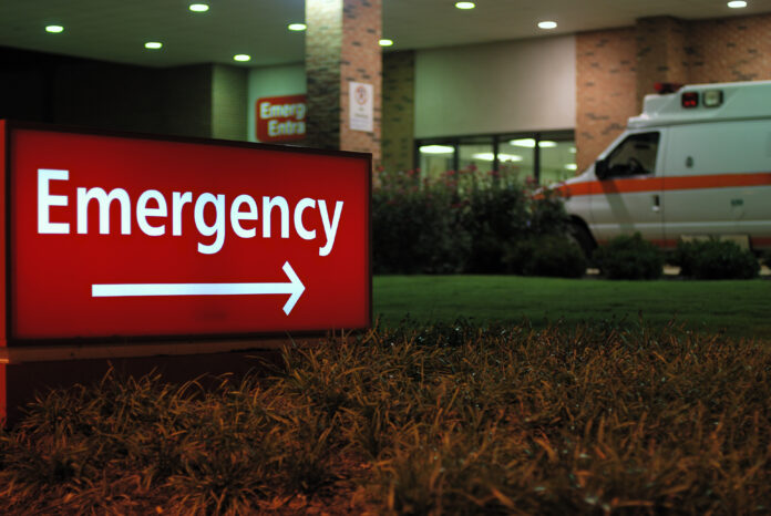 Emergency room entrance sign with ambulance navigating the ER