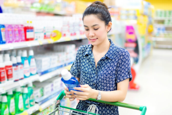 Asian woman buys mouthwash mouthwash
