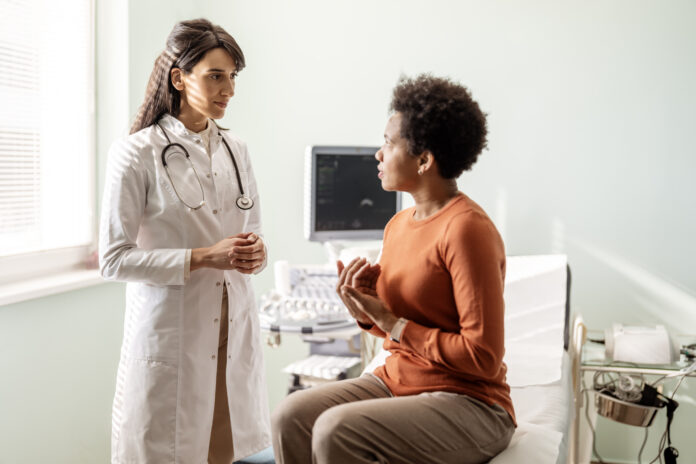 A female doctor talks with her patient in front of her as they talk about her concerns. vaginal dilators