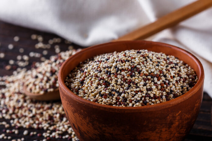 mix of quinoa grains on dark wooden rustic background Quinoa salad