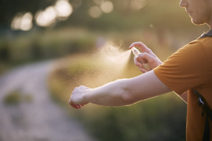 Man applying insect repellent on his hand Insect repellent