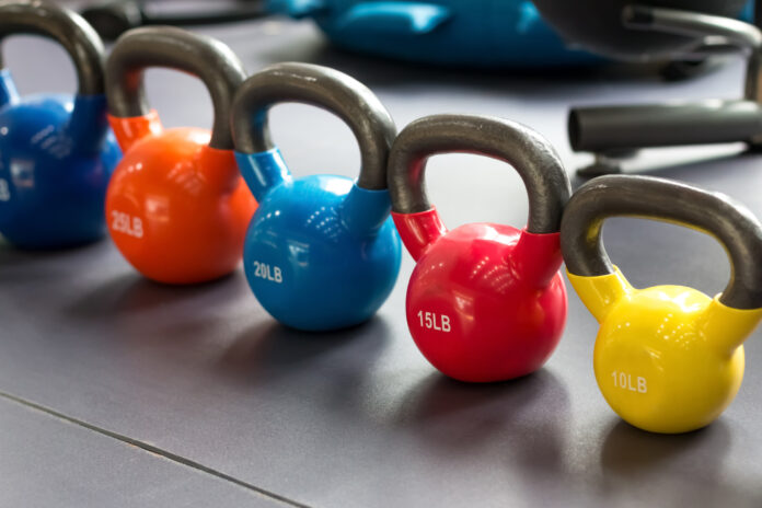 colorful kettlebells lining on table Kettlebells